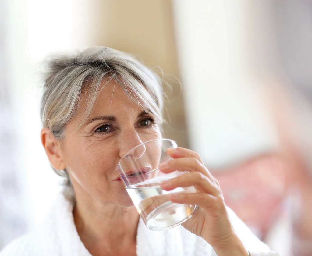 Senior woman drinking a glass of water 